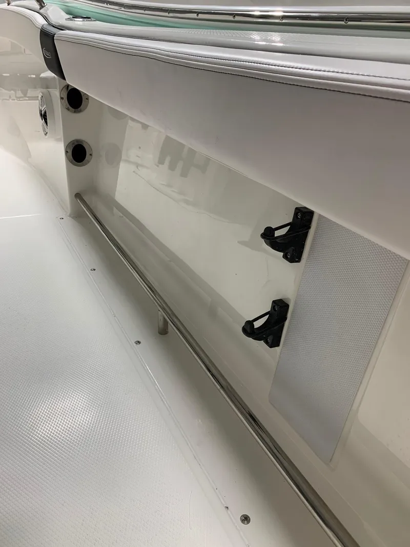 Slide: The Image of 2024 Robalo R222 Explorer boat interior detail with white seating and storage compartments. - 6