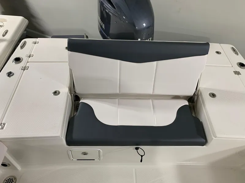 Slide: The Image of 2024 Robalo 226 Cayman boat with cushioned seating and Yamaha outboard motor. - 10