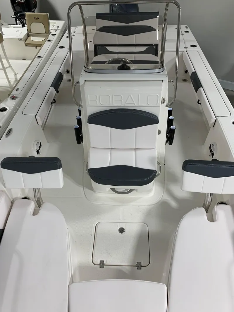 Slide: The Image of 2024 Robalo 226 Cayman boat interior with white and gray seating. - 13