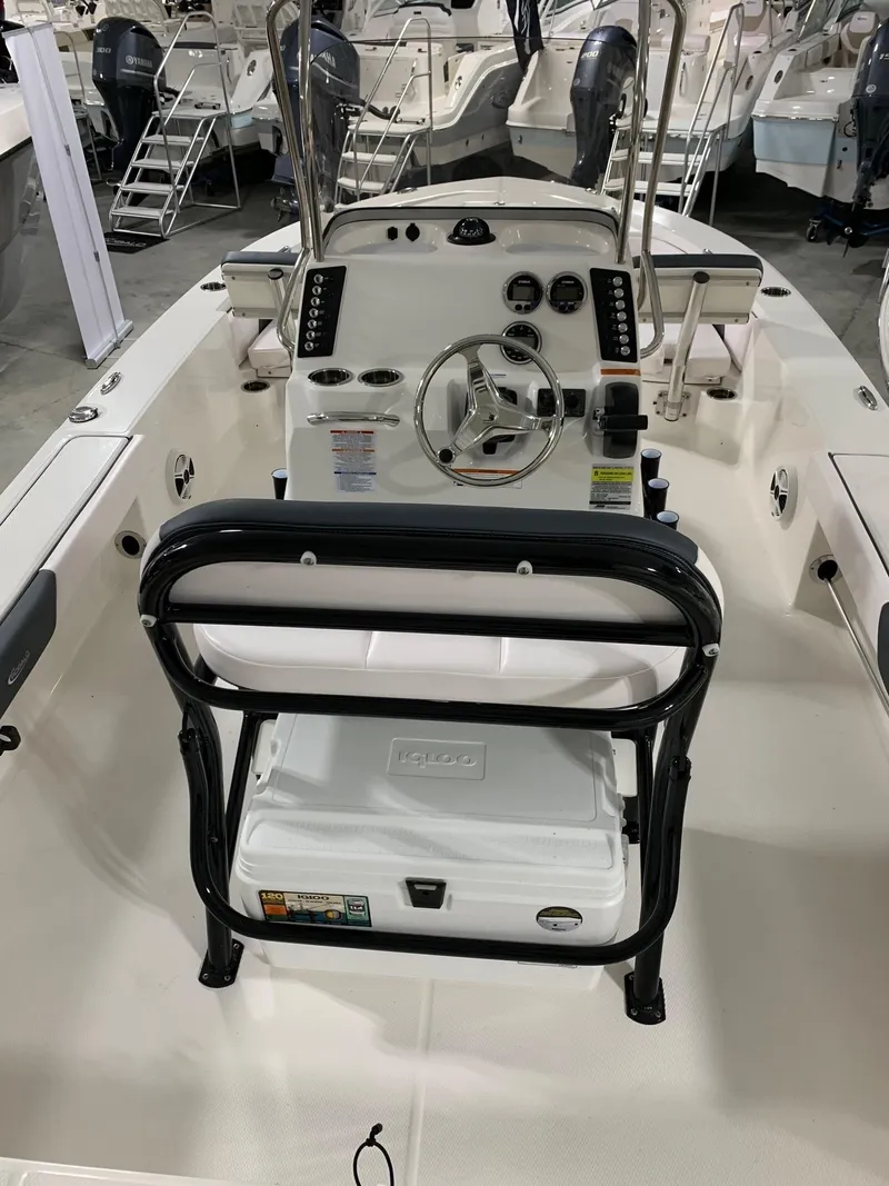 Slide: The Image of 2024 Robalo 226 Cayman center console boat interior with steering wheel and controls. - 7