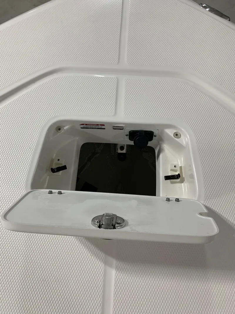 Slide: The Image of 2024 Robalo 226 Cayman boat storage compartment with open hatch. - 15
