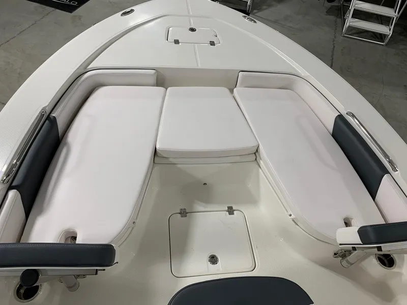 Slide: The Image of 2024 Robalo 226 Cayman boat with cushioned seating area. - 2