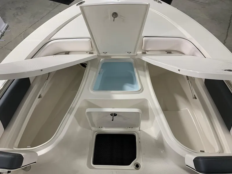 Slide: The Image of 2024 Robalo 226 Cayman boat storage compartments and seating area. - 3