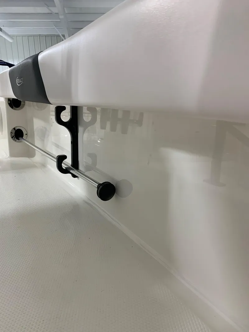 Slide: The Image of 2024 Robalo 226 Cayman boat interior detail showing rod holders and side rail. - 5