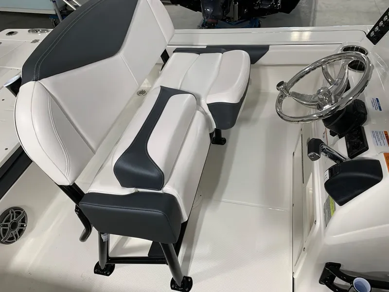Slide: The Image of 2024 Robalo 246 Cayman boat interior with dual seating and steering wheel. - 19