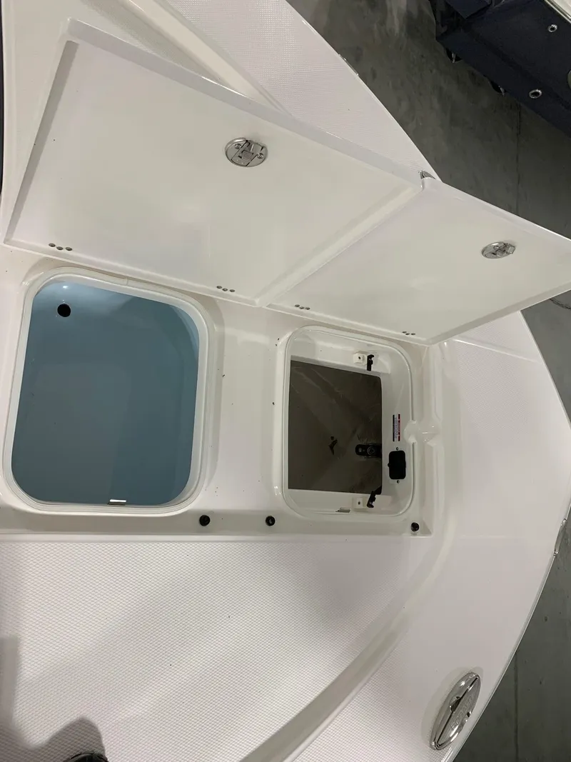 Slide: The Image of 2024 Robalo 246 Cayman boat storage compartments open. - 22