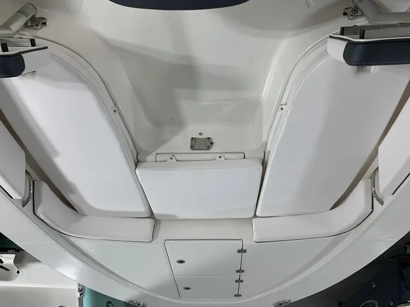Slide: The Image of 2024 Robalo 246 Cayman boat interior seating and storage compartments. - 23