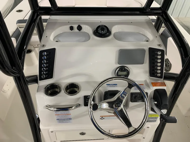 Slide: The Image of 2024 Robalo 246 Cayman boat console with steering wheel and control panel. - 6