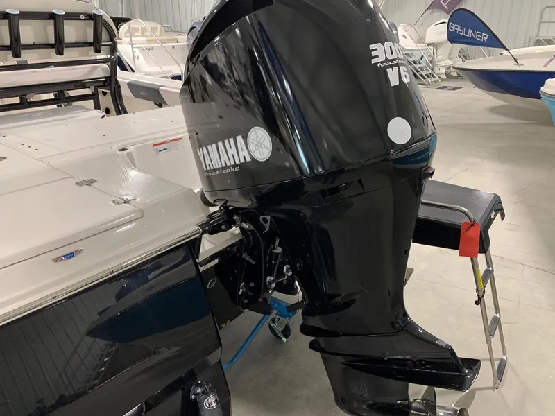 Slide: The Image of 2024 Robalo 246 Cayman with Yamaha 300 V6 outboard motor in showroom. - 8