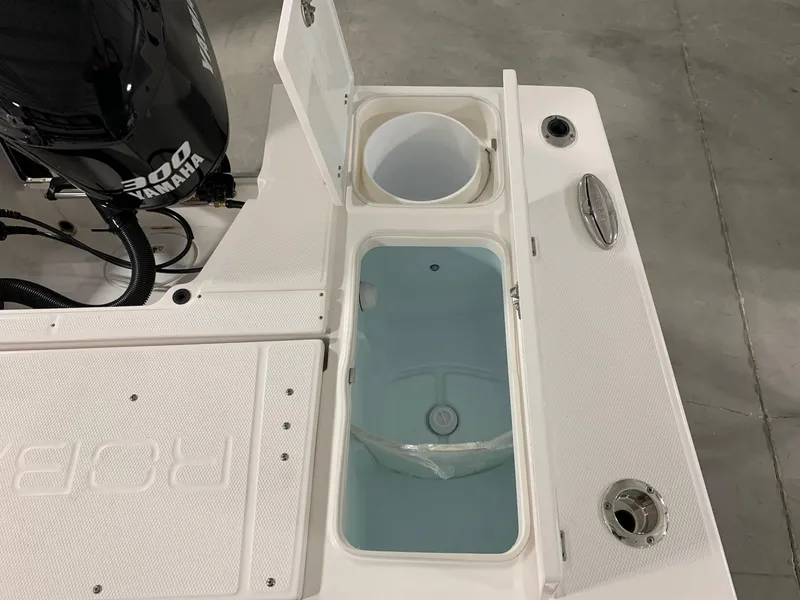 Slide: The Image of 2024 Robalo 246 Cayman boat with Yamaha 300 engine, open storage compartments. - 13