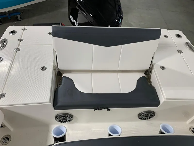 Slide: The Image of 2024 Robalo 246 Cayman boat seating area with storage compartments and cup holders. - 14