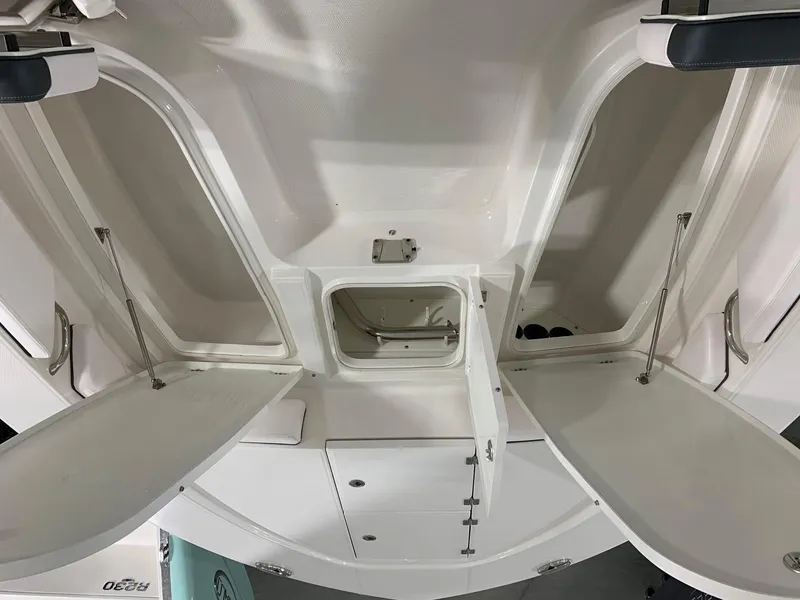 Slide: The Image of 2024 Robalo 246 Cayman boat storage compartments open. - 19