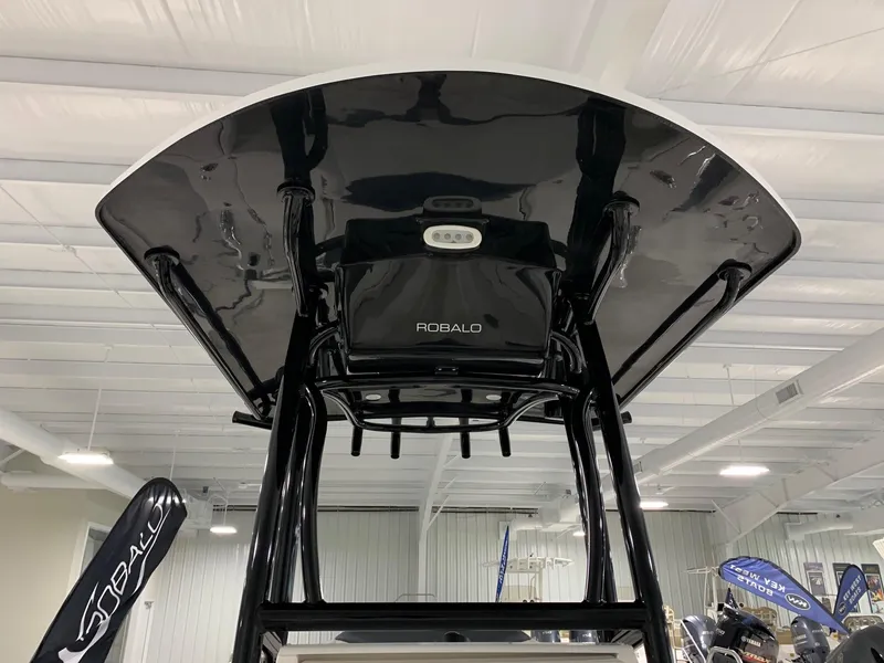 Slide: The Image of 2024 Robalo 246 Cayman boat T-top in showroom. - 4