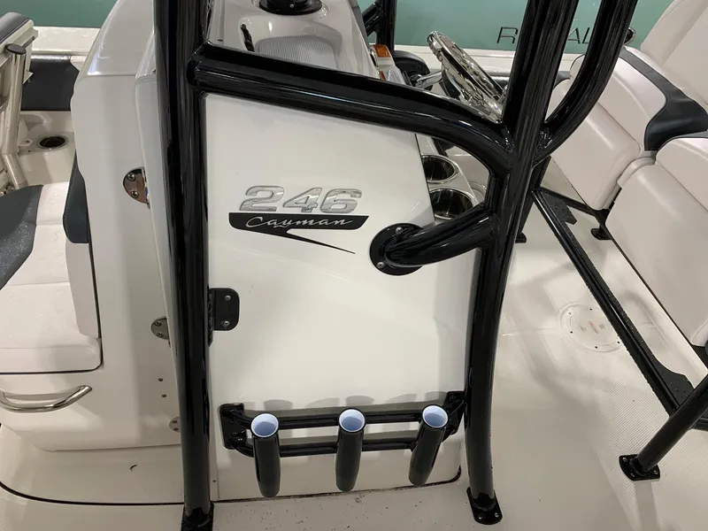 Slide: The Image of 2024 Robalo 246 Cayman boat interior with rod holders and seating. - 7