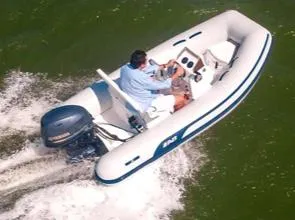 Slide: The Image of 2024 AB Inflatables 10 VSX boat cruising on water. - 2