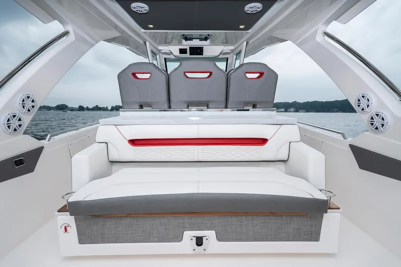 Slide: The Image of 2025 Tiara Sport 34 LS luxury boat interior with seating and scenic water view. - 11