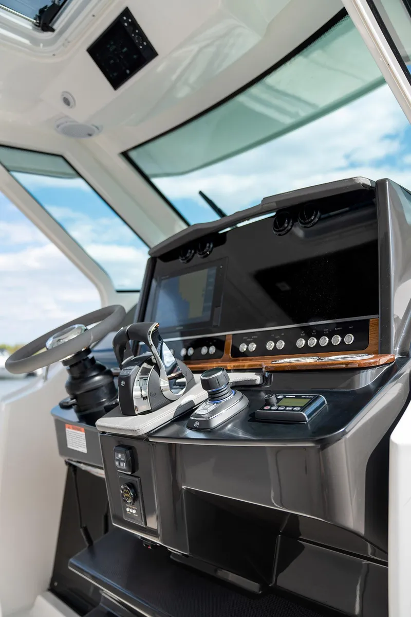Slide: The Image of 2025 Tiara Sport 34 LS boat helm with advanced navigation controls. - 13