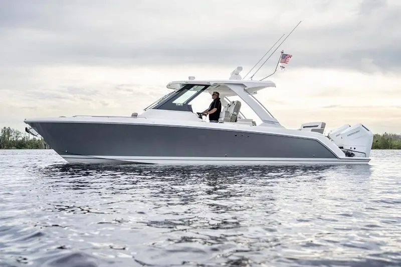 Slide: The Image of 2025 Tiara Sport 34 LS boat cruising on calm water. - 2