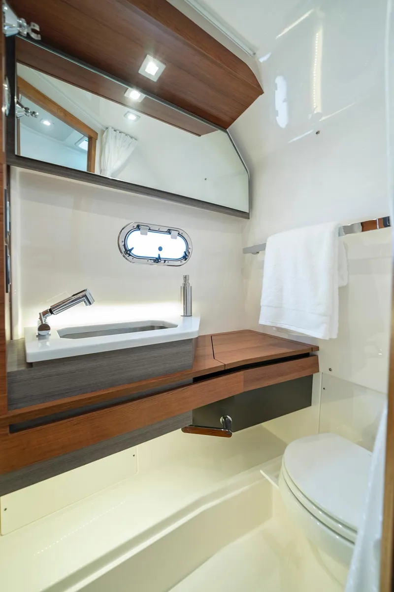 Slide: The Image of 2025 Tiara Sport 34 LS yacht bathroom with modern fixtures and wooden accents. - 25