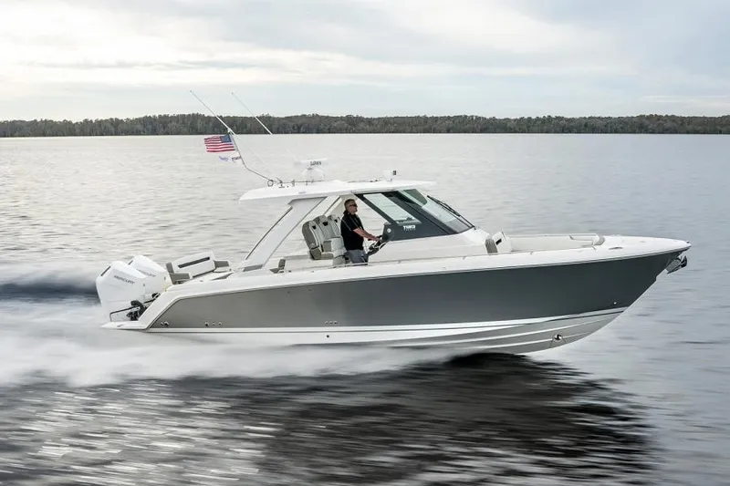 Slide: The Image of 2025 Tiara Sport 34 LS boat cruising on a lake. - 6