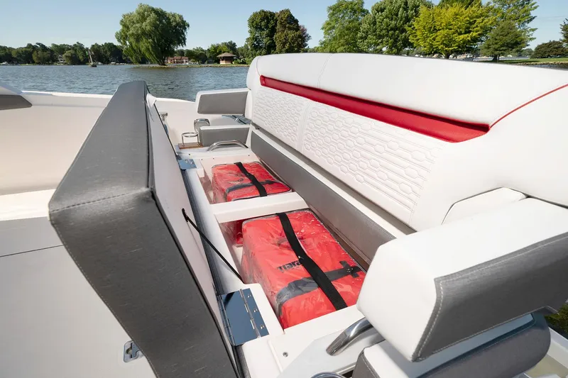 Slide: The Image of 2025 Tiara Sport 34 LS boat seating with storage compartments and life jackets. - 8