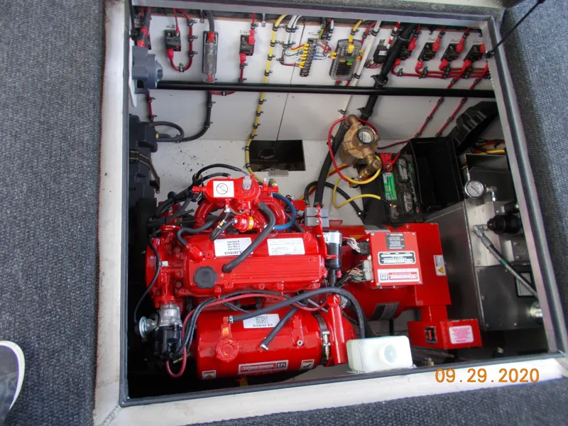 Slide: The Image of Engine compartment of 2020 Sumerset Antelope Escape Share #4 with red machinery and wiring. - 19