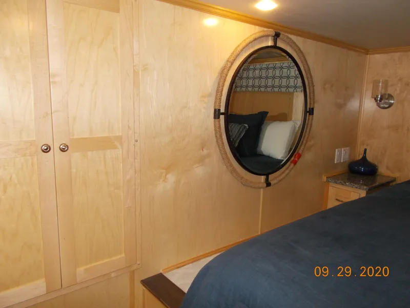 Slide: The Image of Cozy bedroom in 2020 Sumerset Antelope Escape Share #4 with round window and wooden cabinetry. - 24