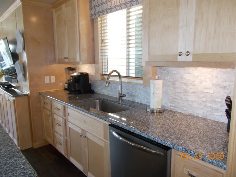 Slide: The Image of Modern kitchen in 2020 Sumerset Antelope Escape Share #4 with granite countertops and stainless steel appliances. - 29