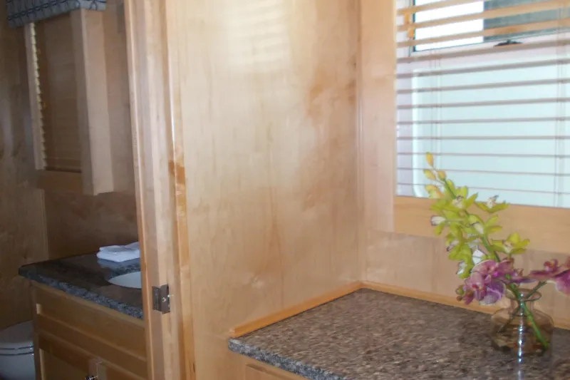 Slide: The Image of 2020 Sumerset Antelope Escape interior with wooden cabinets and granite countertop. - 40