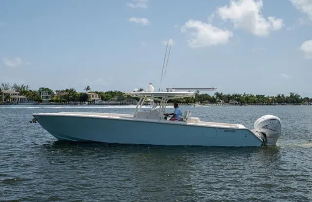 Slide: The Image of 2019 Jupiter 38 HFS boat on calm water under a clear sky. - 11