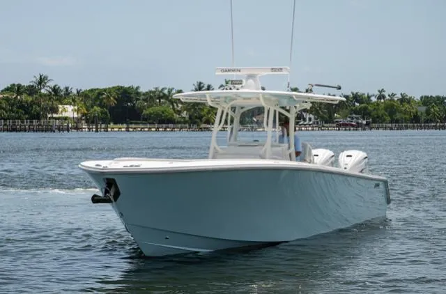 Slide: The Image of 2019 Jupiter 38 HFS boat cruising on a calm waterway with lush greenery in the background. - 12