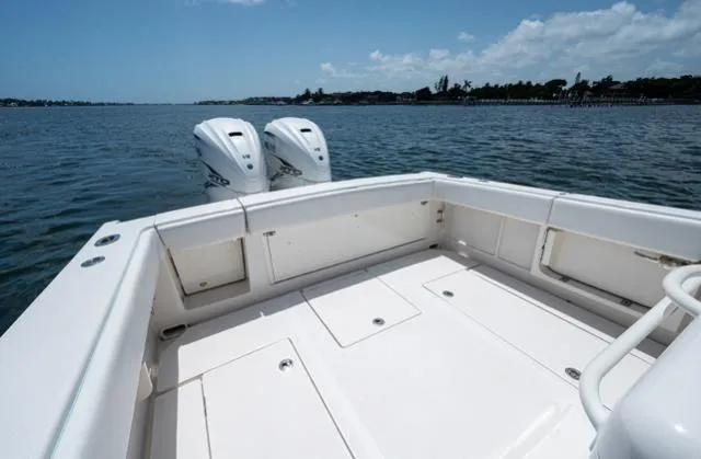 Slide: The Image of 2019 Jupiter 38 HFS boat deck with twin engines on calm water. - 8