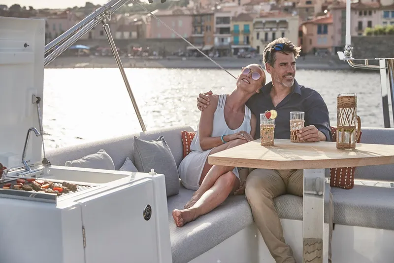 Slide: The Image of Couple relaxing on a 2024 Prestige 420 yacht, enjoying drinks by the waterfront. - 18