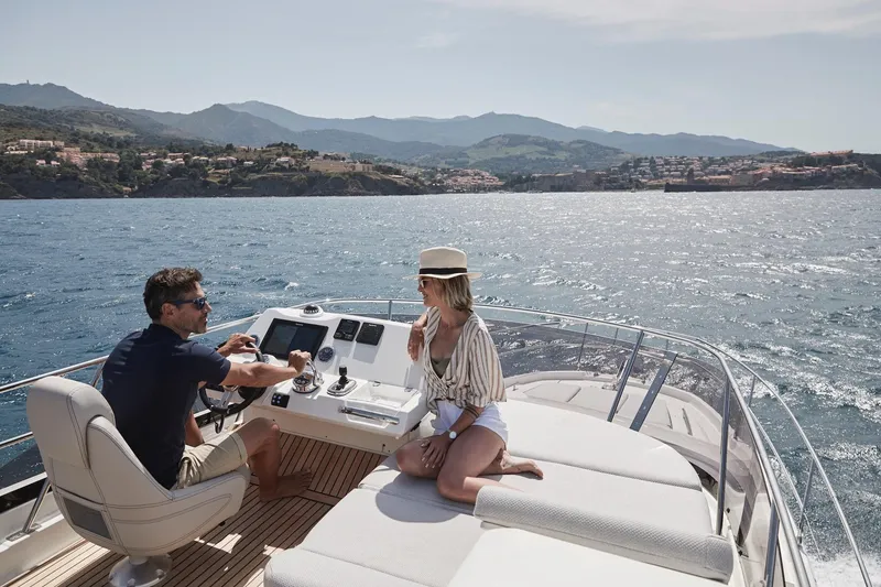 Slide: The Image of Couple enjoying a sunny day on a 2024 Prestige 420 yacht. - 22