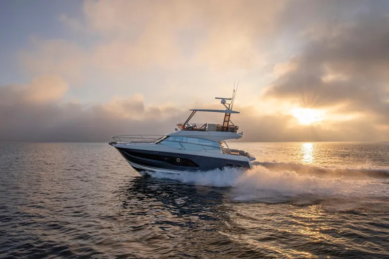 Slide: The Image of 2024 Prestige 420 yacht cruising at sunset on open water. - 8