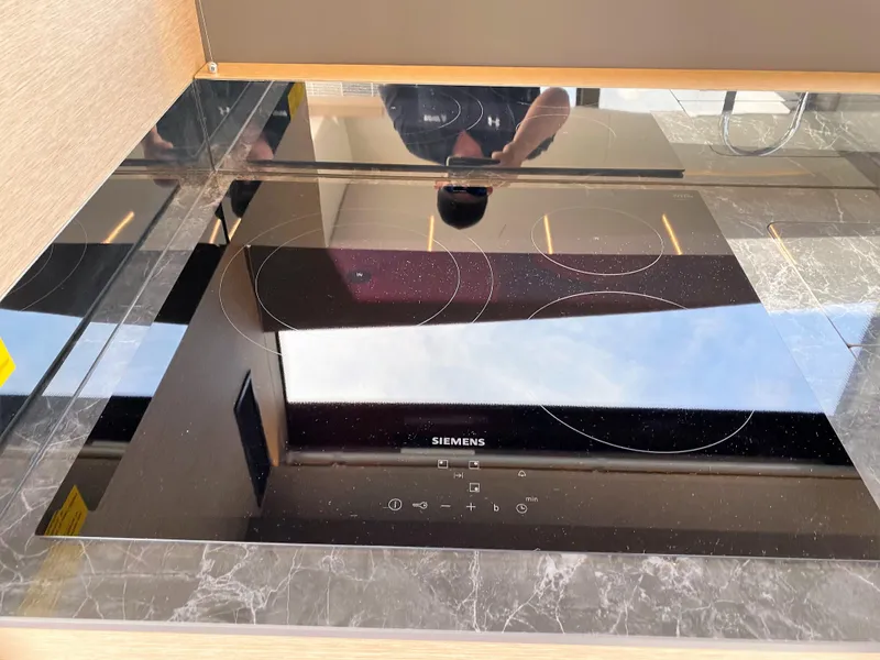 Slide: The Image of Modern Siemens induction cooktop in Prestige 520 S, 2025 model, with sleek black glass surface. - 10