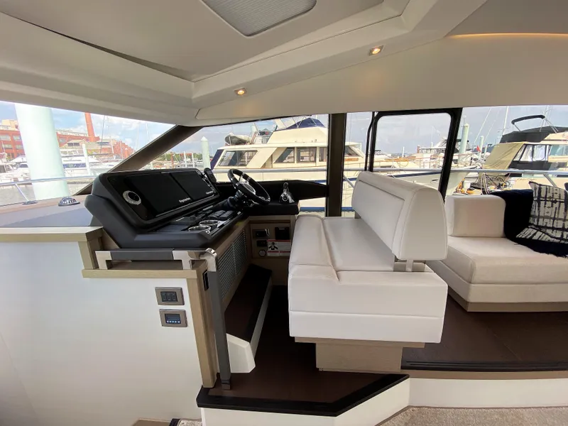 Slide: The Image of 2025 Prestige 520 S yacht interior with modern helm station and luxurious seating. - 14