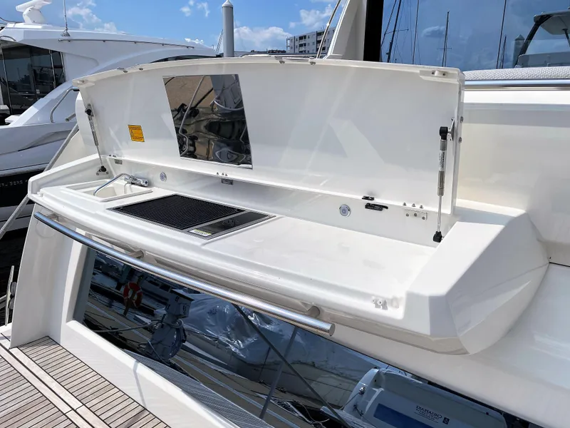 Slide: The Image of Prestige 520 S 2025 yacht with open outdoor kitchen on deck. - 2