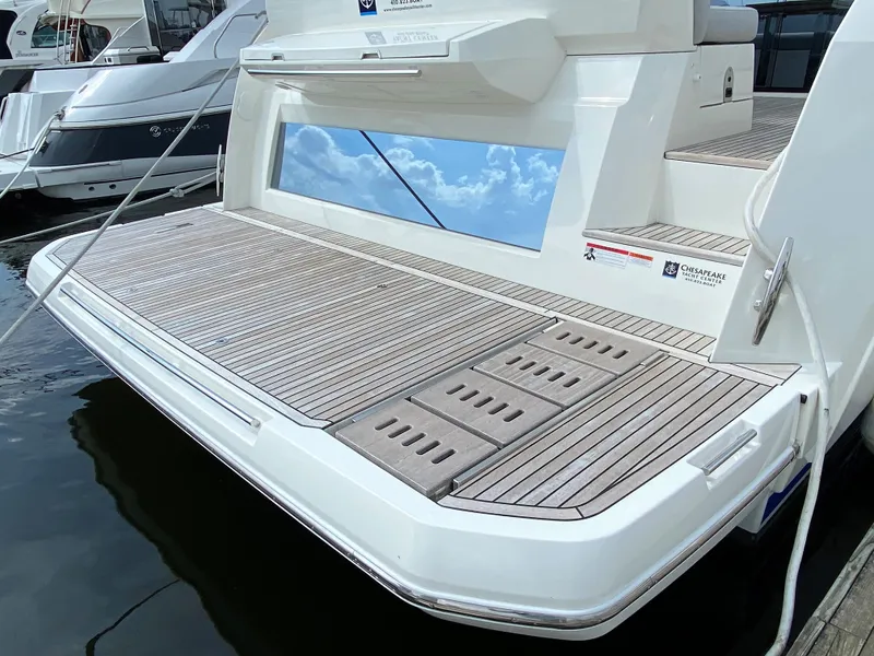 Slide: The Image of Prestige 520 S 2025 yacht with spacious teak swim platform docked at marina. - 3