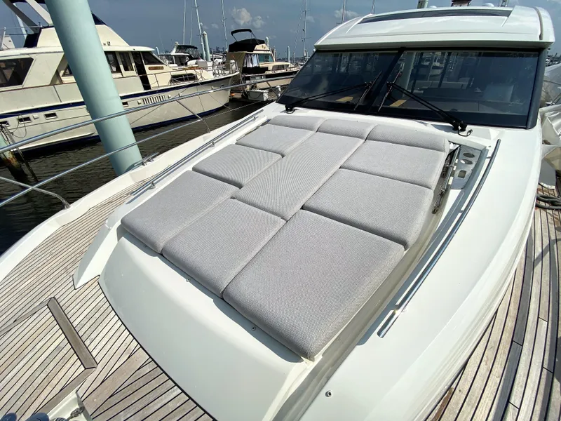 Slide: The Image of Prestige 520 S 2025 yacht with sunbathing area docked at marina. - 39
