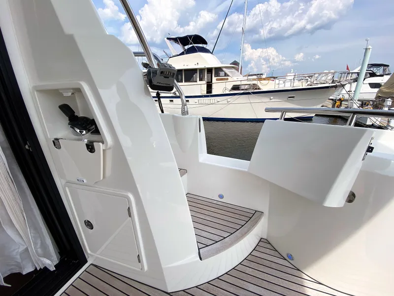 Slide: The Image of Prestige 520 S 2025 yacht deck with marina view, modern design, and luxury features. - 6