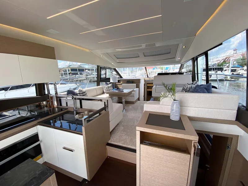 Slide: The Image of Luxurious interior of the 2025 Prestige 520 S yacht with modern furnishings and marina view. - 7