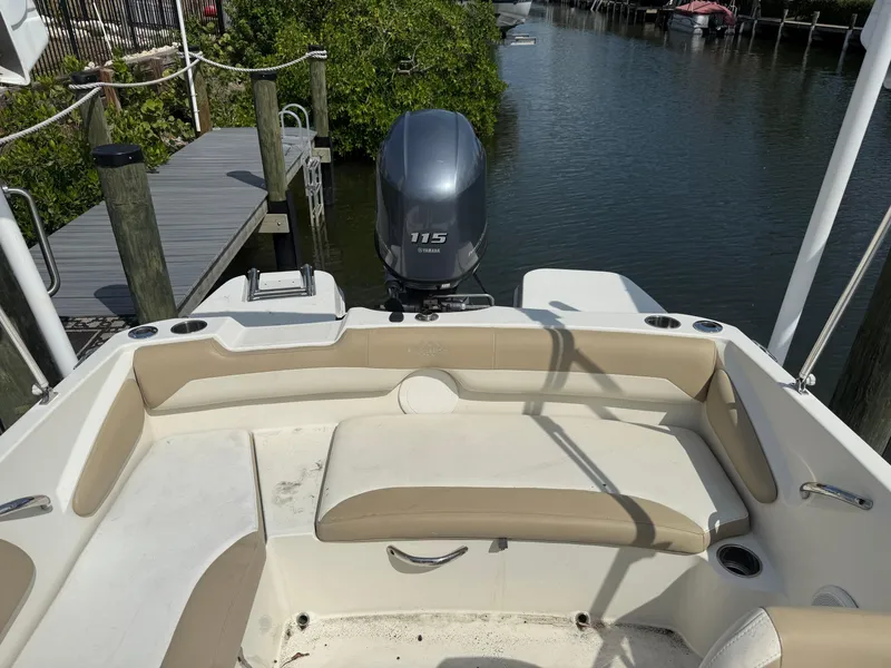 Slide: The Image of 2018 Stingray 191 boat with Yamaha 115 engine, docked by a serene waterway. - 11