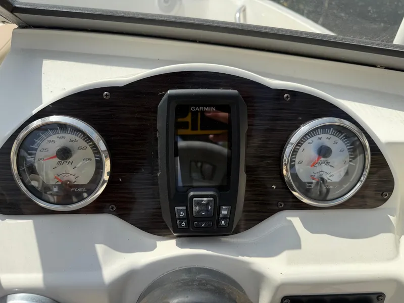 Slide: The Image of Dashboard of a 2018 Stingray 191 boat with Garmin display and gauges. - 20