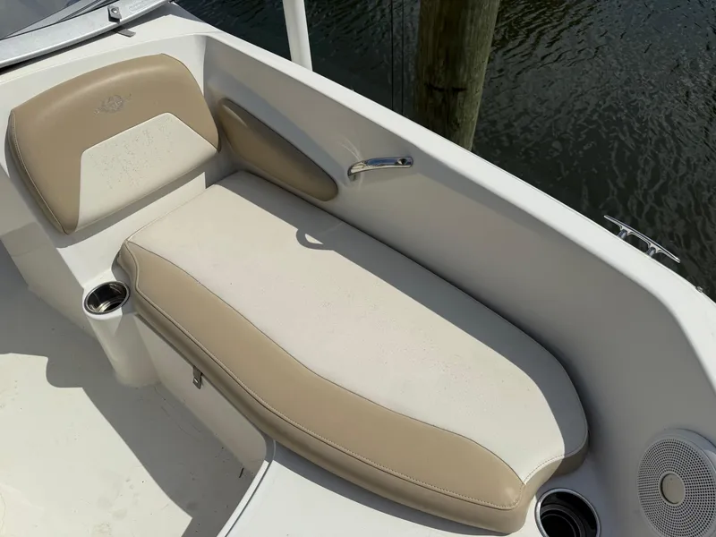 Slide: The Image of 2018 Stingray 191 boat interior with beige seating and cup holders. - 27