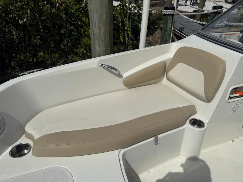 Slide: The Image of 2018 Stingray 191 boat interior with beige seating and cup holders. - 28