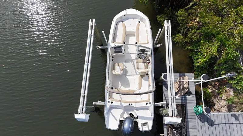 Slide: The Image of Aerial view of a 2018 Stingray 191 boat docked on a lift by the water. - 5