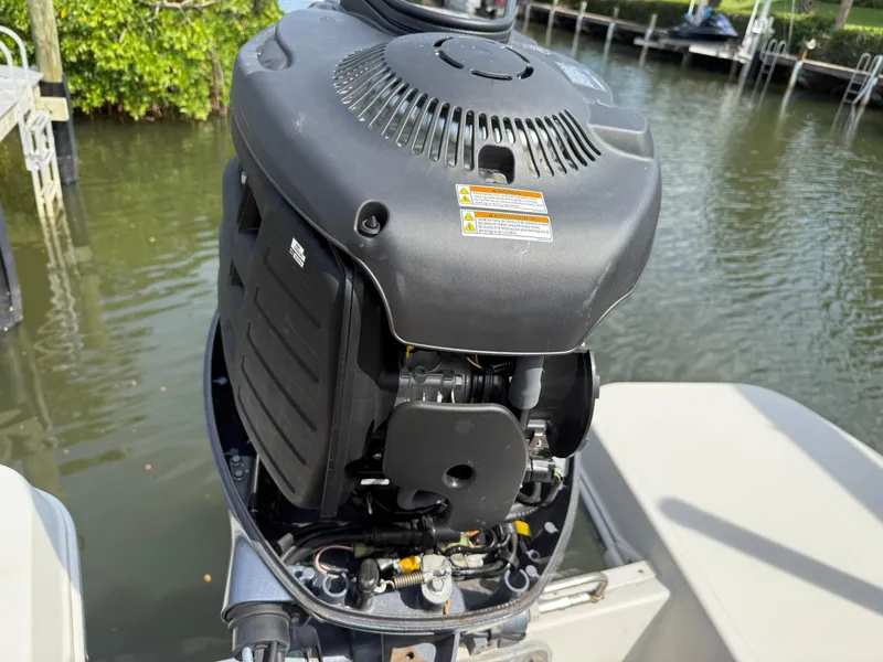Slide: The Image of 2018 Stingray 191 boat engine by the water, showcasing detailed mechanics. - 8