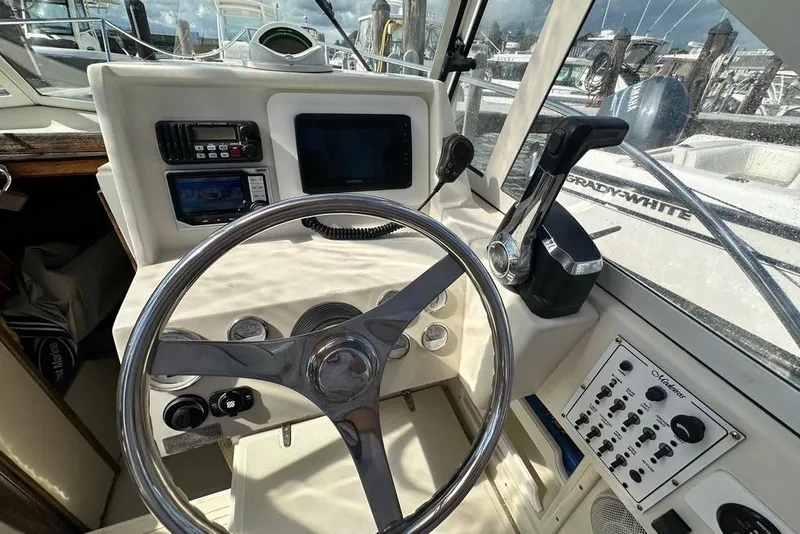 Slide: The Image of Steering console of 2004 Medeiros Limestone 24 Cuddy Cabin boat with controls and gauges. - 30