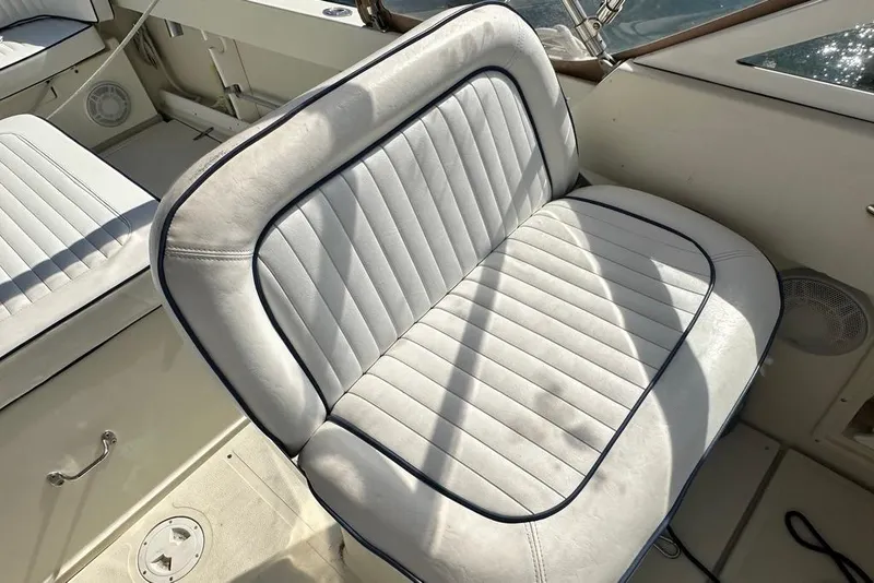 Slide: The Image of White cushioned seat on 2004 Medeiros Limestone 24 Cuddy Cabin boat. - 33